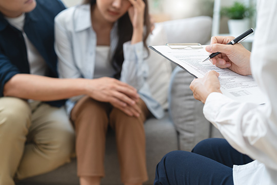 Psychologist talking with a couple during therapy